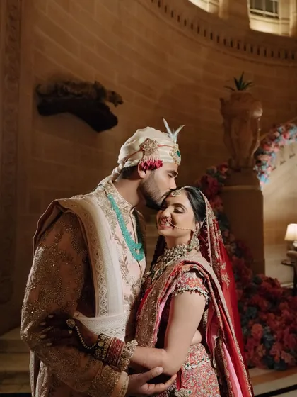 A perfectly coordinated couple. For Nikita and Abhinav's wedding day, we ensured their outfits complemented each other in a way that was regal and timeless, creating picture-perfect moments like this one.