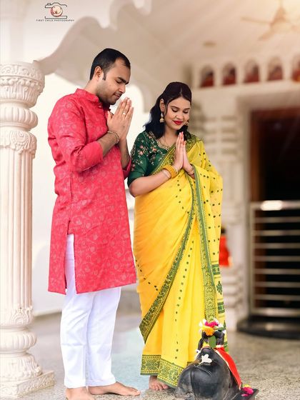 The couple stands with hands joined in prayer, seeking blessings for their unborn child. This photo beautifully captures a moment of shared faith and hope during their outdoor maternity session.