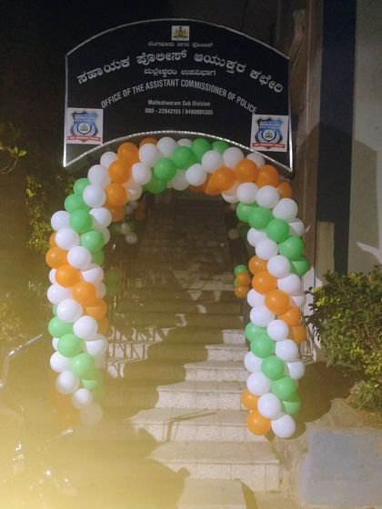 A tricolor balloon arch at the entrance of a police commissioner's office.