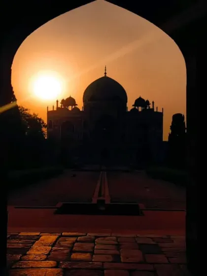 The silhouette of Humayun's Tomb against a fiery sunset, viewed through an archway. These moments of quiet contemplation are a memorable part of my evening walks.