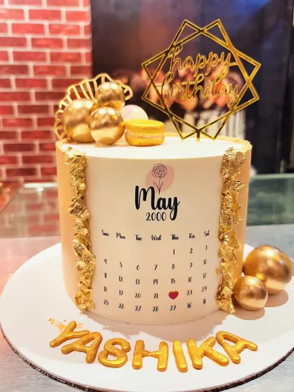 A unique birthday cake featuring an edible calendar page of May 2000, with a heart marking the special day.