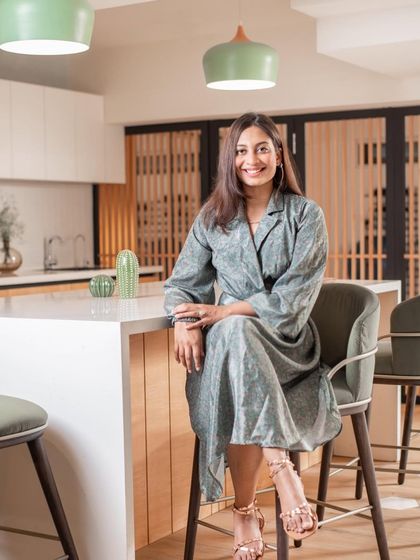 A portrait of my co-founder, Priyanka, blending in with the mood board of our minimalist basement project. Her eye for color and texture is a huge part of our design process.