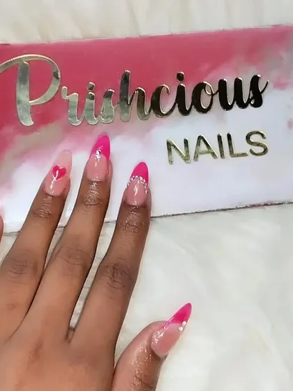 A super sweet Valentine's Day set. This design features pink French tips, tiny heart details, and a delicate rhinestone border on one nail for some extra sparkle.