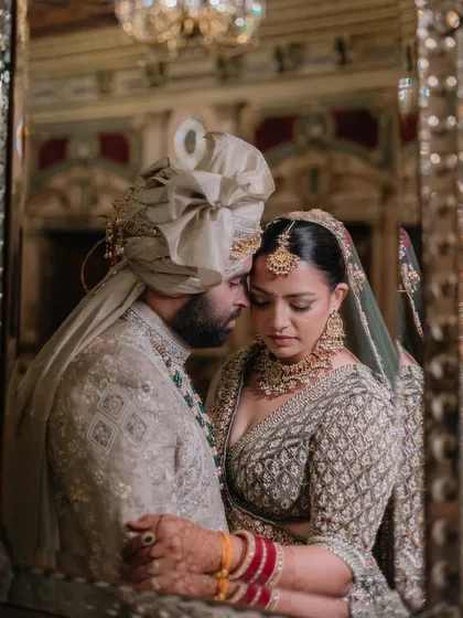 An intimate portrait captured in a gilded mirror at the Yak & Yeti Hotel in Kathmandu, reflecting the couple's quiet connection amidst the grandeur of their surroundings.