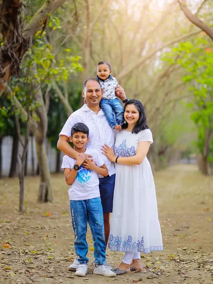 From your first child to your second, we are here to capture your family as it grows. This outdoor portrait shows a beautiful family of four, with natural smiles and easy comfort.