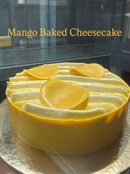 A seasonal favorite, the Mango Baked Cheesecake. It's creamy, rich, and topped with fresh mango slices, capturing the taste of summer in every bite.