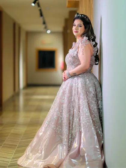 A full-length shot of the bride in her magnificent gown. Her makeup is subtle and elegant, completing her fairytale look.