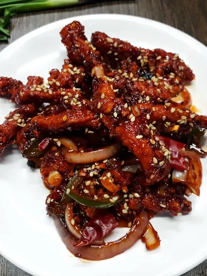 A crowd favourite, our Honey Chilli Crispy Chicken. We fry chicken strips until they are perfectly crunchy and then toss them in a sweet and spicy honey chilli sauce with onions and peppers.