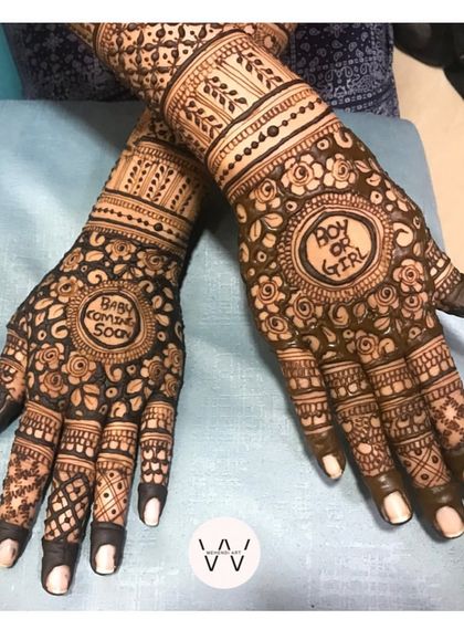 A complete view of the "Baby Coming Soon" design, with intricate floral patterns covering the hands.