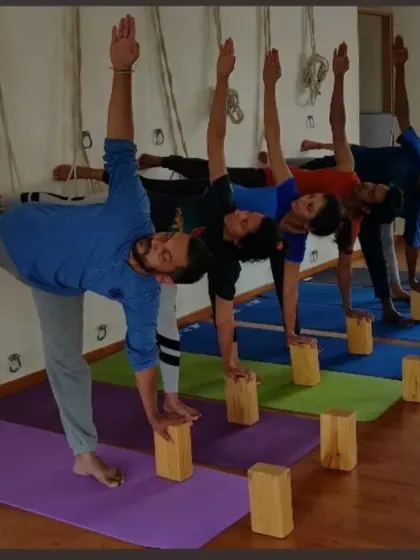 A glimpse into one of my workshops, with students practicing Ardha Chandrasana (Half Moon Pose) using blocks and a rope wall for stability. This demonstrates how we use props to achieve precise alignment in a group setting.