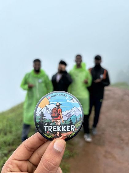 A creative shot of our "I am a Trekker" badge with our team in the background on the Bandaje trail.
