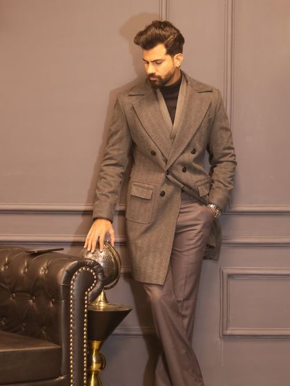 The craftsmanship of our long coat is evident in its structured shoulders and perfectly tailored lines.