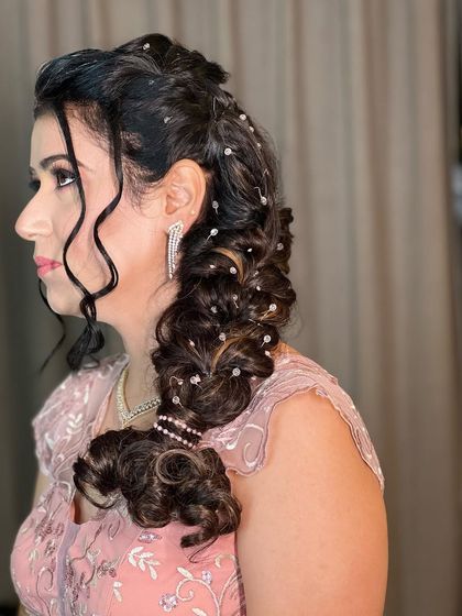 The side profile of this glamorous braid, perfect for showing off statement earrings and a dazzling smile.