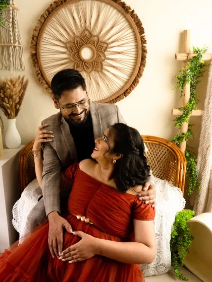 A close-up shot of the couple making a heart shape on the baby bump. It's a classic and heartwarming pose that symbolizes your shared love for your coming baby.