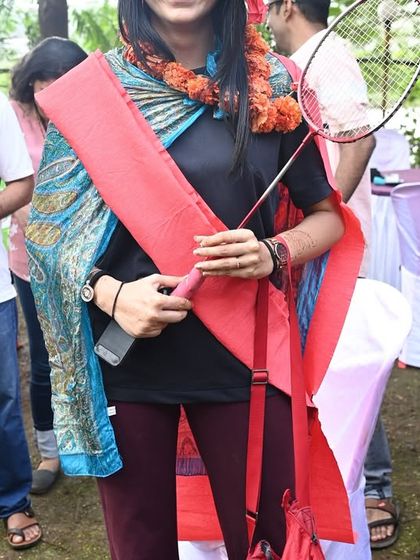 A participant proudly displaying her team's winning props after a game. I love to celebrate the winners and make everyone feel like they've accomplished something together.