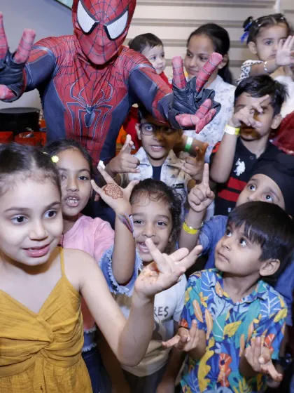 Imagine the look on your child's face when their favorite hero joins the party. We can arrange for special character appearances, like Spider-Man here, to surprise the kids and create unforgettable photo moments.