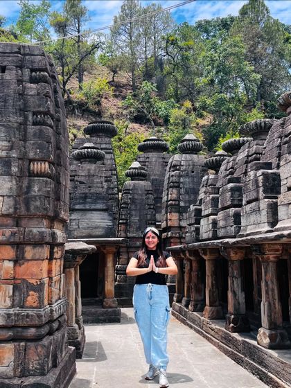 Feeling blessed at an ancient temple in Ranikhet. For this trip, I opted for a comfortable and casual look with a black t-shirt and light-wash cargo jeans.