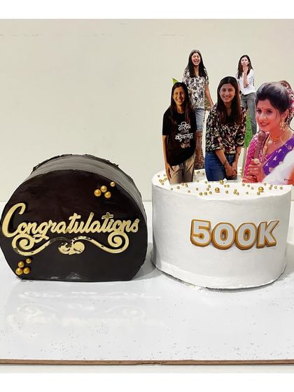 A set of two top forward cakes for a 500k celebration. One is a rich ganache cake and the other is a vanilla strawberry, showing the versatility of this style.