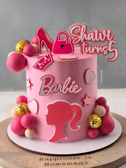 A stylish Barbie cake for a 5th birthday, featuring a silhouette and other fashion-themed toppers. This is a 1.5kg Fresh Strawberry Chocolate cake.