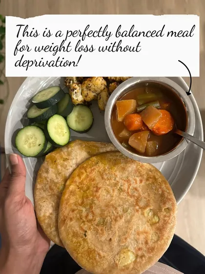 This is a perfectly balanced meal for weight loss without deprivation: a stuffed paratha with sambar and a side of cucumber.