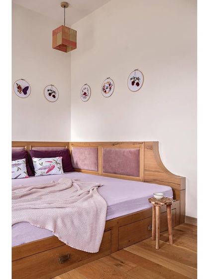 For this guest bedroom, I departed from a neutral palette and chose a vibrant wine hue for the wardrobes. To add texture, I sandwiched fabric within the glass panels of the shutters.
