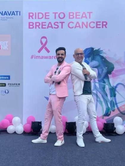 Back to back with my co-host, ready to energize the crowd for a great cause.