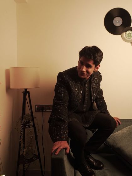 Another shot of Ahsan Vazir in our black embroidered jacket, showing how it looks in a relaxed, stylish setting.