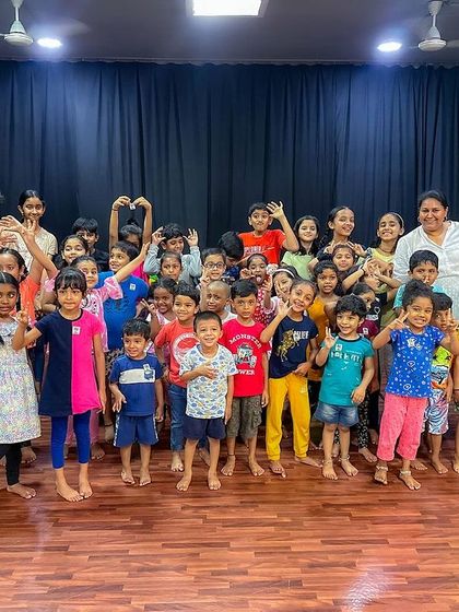 A big group photo after a fun-filled puppet show at a studio. Look at all those happy, energetic faces.