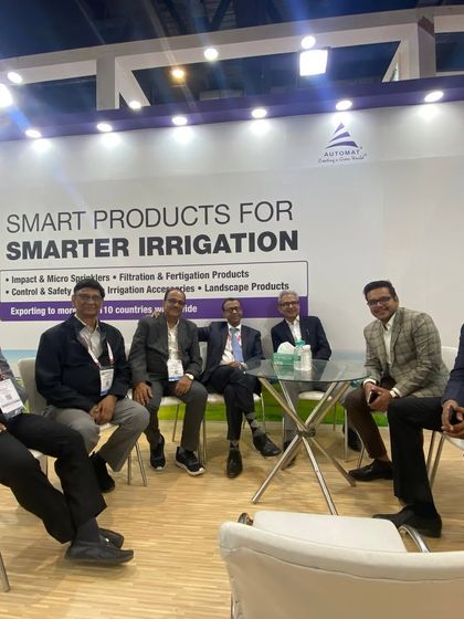 Our leadership and sales team meeting with partners at PlastIndia 2023. The backdrop clearly states our mission: "Smart Products for Smarter Irrigation."