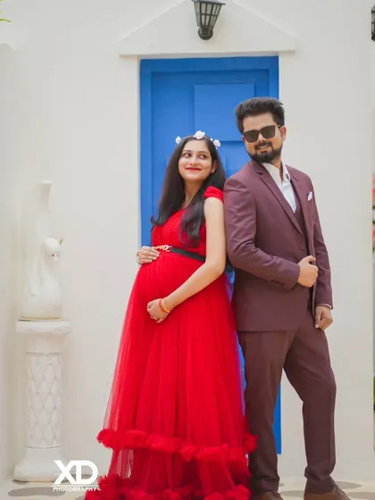A stylish couple posing against the Santorini-inspired backdrop, exuding a cool and modern vibe.