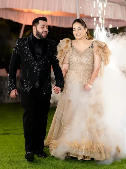 A beautiful shot of the couple making their entrance at the Sangeet, hand in hand.