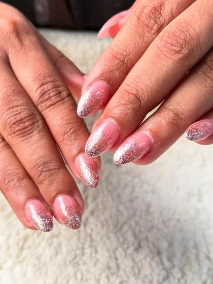 A pink and silver glitter ombre on rounded nails. This is a classic glamorous look that is always popular.