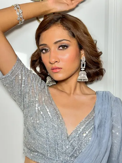 A direct look at this stunning silver eye makeup. It is bold, reflective, and perfect for making a statement at an evening event.
