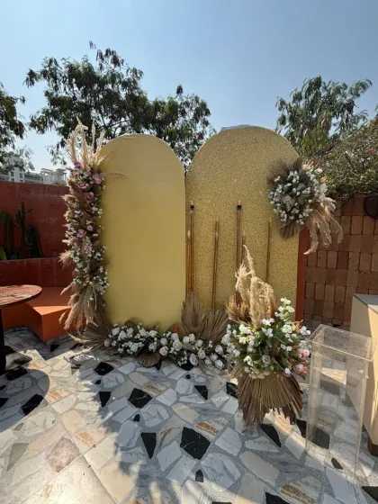 A daytime view of the 40th birthday setup, showing the gold shimmer wall and velvet backdrop before the party begins.