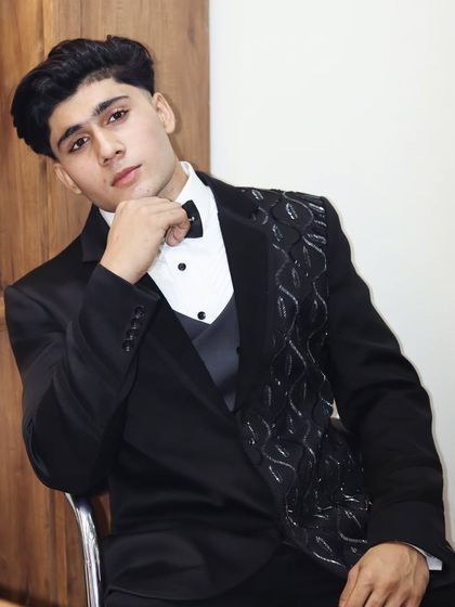 A different angle of this unique black tuxedo, showing the textured lapel detail. It's a perfect example of how we can add a custom touch to a classic look.