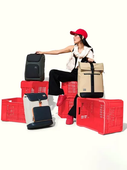A styled shot for Urban Jungle's backpack line. The model's makeup is clean and modern with a hint of attitude, featuring a defined brow and a neutral lip to match the casual, trendy styling.