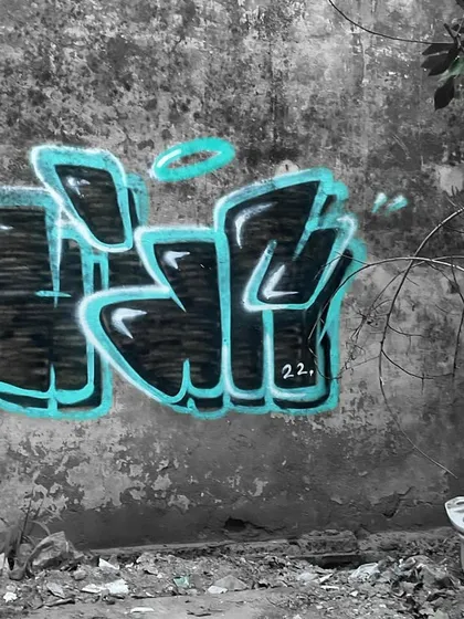 A clean shot of my "Yogi" throw-up on an abandoned wall. The black and turquoise color scheme pops against the monochrome background, highlighting the letter structure and 3D effect. This is my signature style.