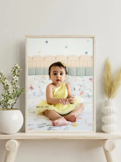 A framed portrait of your little sunbeam is a beautiful addition to any room. This photo shows how a simple, happy baby picture can become a cherished piece of home decor.