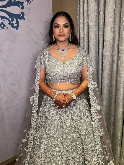 The complete cocktail look for Ishita. Her smokey glam makeup perfectly complements her sparkling Seema Gujral lehenga.