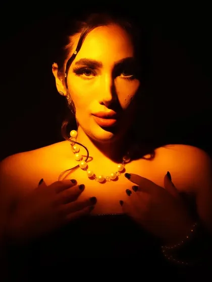 Playing with light and shadow to create a dramatic, conceptual portrait. The makeup is minimal yet impactful, with a focus on glowing skin and defined features that emerge from the darkness.