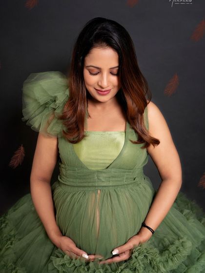 A quiet moment of reflection. Looking down at her bump, this portrait captures the deep, personal bond a mother feels with her unborn child.