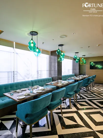 The striking geometric flooring and modern decor of Zodiac create a visually dynamic and upscale dining environment.