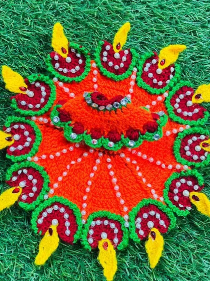 Illuminate your celebrations with this special Diwali diya poshak. The bright orange dress is decorated with small, handmade crochet diyas, each with a yellow flame, making it a perfect festive attire for your Kanha Ji.