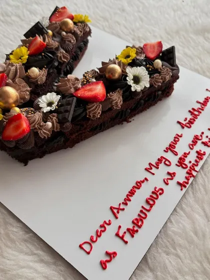 A "V" letter cake for a fabulous wife's birthday. This chocolate cake is loaded with frosting, fresh strawberries, and flowers.
