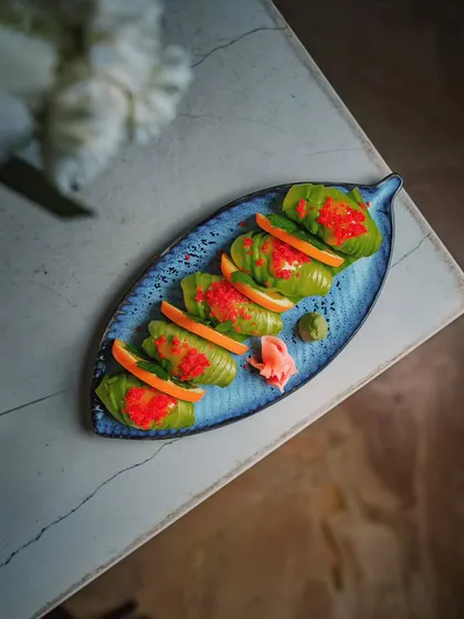 A plate of our beautiful Avocado Nigiri, where simplicity and flavor meet. The bright red tobiko adds a pop of color and texture.