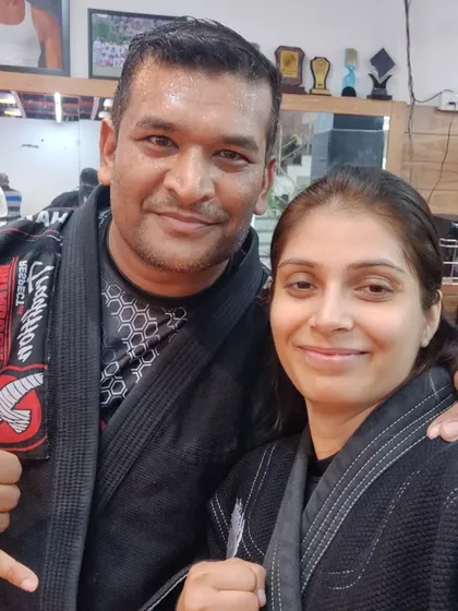 A photo with a respected senior practitioner after a tough but rewarding BJJ training session. The grappling community is built on mutual respect and a shared passion for learning.