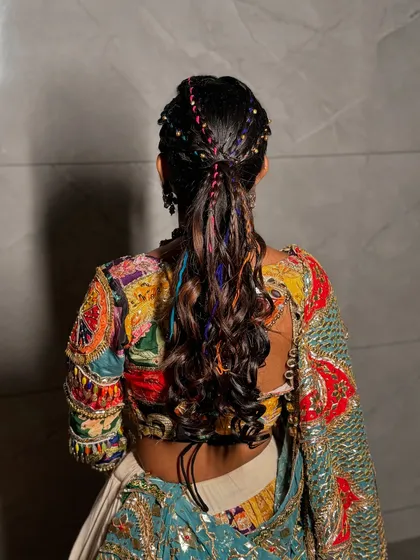 A closer look at the colorful braided details in this Navratri hairstyle.