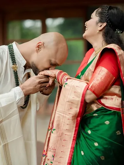 A moment of pure adoration and tradition. We focus on capturing gestures like these that speak volumes, blending chivalry with the rich textures of heritage attire.