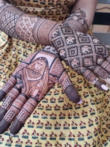 A beautiful design featuring a bride's portrait on one palm and a dense pattern of elephants on the other.