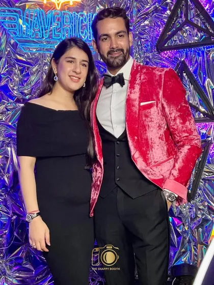 A stylish couple posing at the Maverick-themed gala. We provide a high-end experience that matches the sophistication of your corporate function.